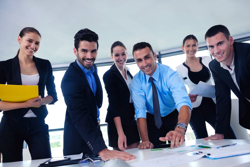 Group of happy young  business people in a meeting at office